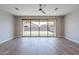 Open-concept living room with tile flooring and large sliding doors offer picturesque views of the landscaped backyard at 4467 S 116Th Ln, Avondale, AZ 85323
