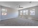 This main bedroom is spacious and bright, featuring plush carpeting and multiple windows with natural light at 4467 S 116Th Ln, Avondale, AZ 85323