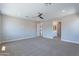 Expansive main bedroom featuring plush carpeting, ceiling fan, and en-suite bathroom at 4467 S 116Th Ln, Avondale, AZ 85323