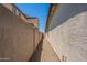 The side yard features a gravel ground cover and a tall block wall providing added privacy at 4467 S 116Th Ln, Avondale, AZ 85323
