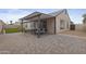 Paver patio features an entertaining area with overhead awning and modern outdoor furniture at 4632 E Kachina Trl, Phoenix, AZ 85044