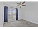 Bright bedroom with carpeted floors, large window, and ceiling fan at 4632 E Kachina Trl, Phoenix, AZ 85044