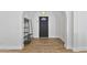 The entryway features neutral walls, wood floors, and coatrack next to the black front door at 4632 E Kachina Trl, Phoenix, AZ 85044