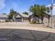 Well-maintained single-Gathering home featuring desert landscaping, a gray roof, and palm trees at 4632 E Kachina Trl, Phoenix, AZ 85044