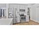 Modern kitchen featuring stainless steel appliances, white cabinets, and subway tile backsplash at 4632 E Kachina Trl, Phoenix, AZ 85044