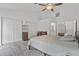Spacious main bedroom featuring carpeted floors, ceiling fan, ensuite bathroom access, and ample natural light at 4632 E Kachina Trl, Phoenix, AZ 85044