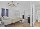 Bright primary bedroom with neutral carpet, natural light, and en suite bathroom and closet at 4632 E Kachina Trl, Phoenix, AZ 85044