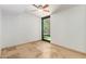 Bedroom with a ceiling fan, marble-like floors, and a large window overlooking an outdoor area at 4808 N 24Th St # 231, Phoenix, AZ 85016