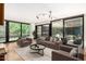 Bright living room featuring floor-to-ceiling windows, stylish furniture, and contemporary lighting at 4808 N 24Th St # 231, Phoenix, AZ 85016