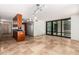 Bright living room featuring travertine floors, track lighting, and an open floorplan to the kitchen at 4808 N 24Th St # 231, Phoenix, AZ 85016
