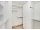Bright walk-in closet featuring custom white shelving and cabinets for optimal storage and organization at 4808 N 24Th St # 231, Phoenix, AZ 85016