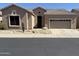 Desert-landscaped Southwest-style home, featuring a two-car garage and covered entry at 4944 E Villa Theresa Dr, Scottsdale, AZ 85254