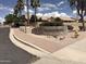 Community entrance sign with lush landscaping and mature trees at 4944 E Villa Theresa Dr, Scottsdale, AZ 85254