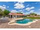Relaxing backyard featuring a private pool, patio, lounge chairs, and lush landscaping at 4953 W Acoma Dr, Glendale, AZ 85306
