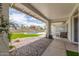 Tranquil backyard with pool, artificial grass, rock landscaping, and covered patio at 4953 W Acoma Dr, Glendale, AZ 85306