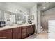 This bathroom offers double sinks, a large vanity and a walk-in shower at 4953 W Acoma Dr, Glendale, AZ 85306