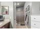 Bathroom featuring a walk-in shower, neutral color scheme, and vanity with storage at 4953 W Acoma Dr, Glendale, AZ 85306