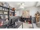 Well-decorated bedroom featuring custom shelves, ceiling fan, and gray walls at 4953 W Acoma Dr, Glendale, AZ 85306