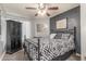 A spacious bedroom with fan, carpet and a black accent wall at 4953 W Acoma Dr, Glendale, AZ 85306