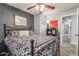 This bedroom features carpet, a ceiling fan and black accent wall at 4953 W Acoma Dr, Glendale, AZ 85306