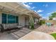 Comfortable covered patio with an outdoor sofa, chairs, and view of the landscaped yard at 4953 W Acoma Dr, Glendale, AZ 85306