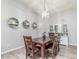 Elegant dining room featuring a dark wood table, leather chairs, and decorative wall shelves at 4953 W Acoma Dr, Glendale, AZ 85306