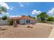 Charming single-story home featuring a red tile roof, arched windows, and a low-maintenance desert landscape at 4953 W Acoma Dr, Glendale, AZ 85306