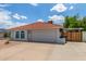 Well-maintained house with a red tile roof, two-car garage and low-maintenance desert landscaping at 4953 W Acoma Dr, Glendale, AZ 85306