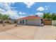 Well-maintained house with a red tile roof, two-car garage and low-maintenance desert landscaping at 4953 W Acoma Dr, Glendale, AZ 85306