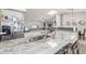 Spacious kitchen island with white cabinets, stainless steel appliances, and modern finishes at 4953 W Acoma Dr, Glendale, AZ 85306