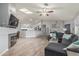 Spacious living room featuring new flooring, fireplace, comfortable seating, and open access to kitchen at 4953 W Acoma Dr, Glendale, AZ 85306