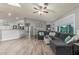 Open-concept living room features new flooring, vaulted ceilings, neutral colors, and comfortable seating at 4953 W Acoma Dr, Glendale, AZ 85306