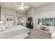 This spacious main bedroom features neutral colors, an ensuite bathroom, and a large window for natural light at 4953 W Acoma Dr, Glendale, AZ 85306