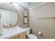 Elegant powder room with stylish wallpaper, a gold-framed mirror, and modern fixtures at 5201 N 24Th St # 107, Phoenix, AZ 85016