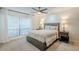Well-lit bedroom with neutral tones, ceiling fan, and views from the window at 5201 N 24Th St # 107, Phoenix, AZ 85016
