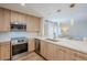 Modern kitchen with quartz countertops, stainless steel appliances, and pendant lighting at 5201 N 24Th St # 107, Phoenix, AZ 85016