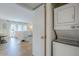 Modern laundry room with stacked washer and dryer; living space in background at 5201 N 24Th St # 107, Phoenix, AZ 85016
