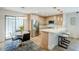 Inviting dining and kitchen area with modern appliances, breakfast bar, and chic lighting at 5201 N 24Th St # 107, Phoenix, AZ 85016