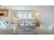 Cozy living room with a plush sofa, transparent coffee table, and bright natural light from large windows at 5201 N 24Th St # 107, Phoenix, AZ 85016