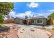 A sprawling backyard showcases hardscape design, a barbecue, and mature landscaping at 5210 W Ironwood Dr, Glendale, AZ 85302