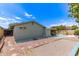 View of the backyard showing a hardscape design, privacy fence, and covered porch at 5210 W Ironwood Dr, Glendale, AZ 85302