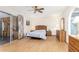 Spacious bedroom with a ceiling fan, sliding doors, and neutral tones at 5210 W Ironwood Dr, Glendale, AZ 85302
