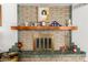 Close-up of a charming brick fireplace with decorative mantle at 5210 W Ironwood Dr, Glendale, AZ 85302