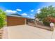 Brick house featuring a well-maintained front yard with an attached two-car garage at 5210 W Ironwood Dr, Glendale, AZ 85302