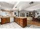 The kitchen area opens into a spacious living room with a stone fireplace and a light-filled space at 5210 W Ironwood Dr, Glendale, AZ 85302