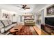 Cozy living room with hardwood floors leading to an eat-in kitchen and large slider at 5210 W Ironwood Dr, Glendale, AZ 85302