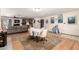 Open-concept living room features an elegant dining area, fireplace and hardwood floors at 5210 W Ironwood Dr, Glendale, AZ 85302
