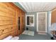 Cozy porch area with wood accents, a security screen door, and neutral tones for outdoor relaxation at 5210 W Ironwood Dr, Glendale, AZ 85302