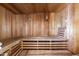 A cedar sauna offers a tranquil retreat, featuring multi-tiered benches and a soothing ambiance at 5210 W Ironwood Dr, Glendale, AZ 85302