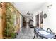 A spacious sunroom with tile floor, wood paneling, and views of the backyard through sliding glass doors at 5210 W Ironwood Dr, Glendale, AZ 85302